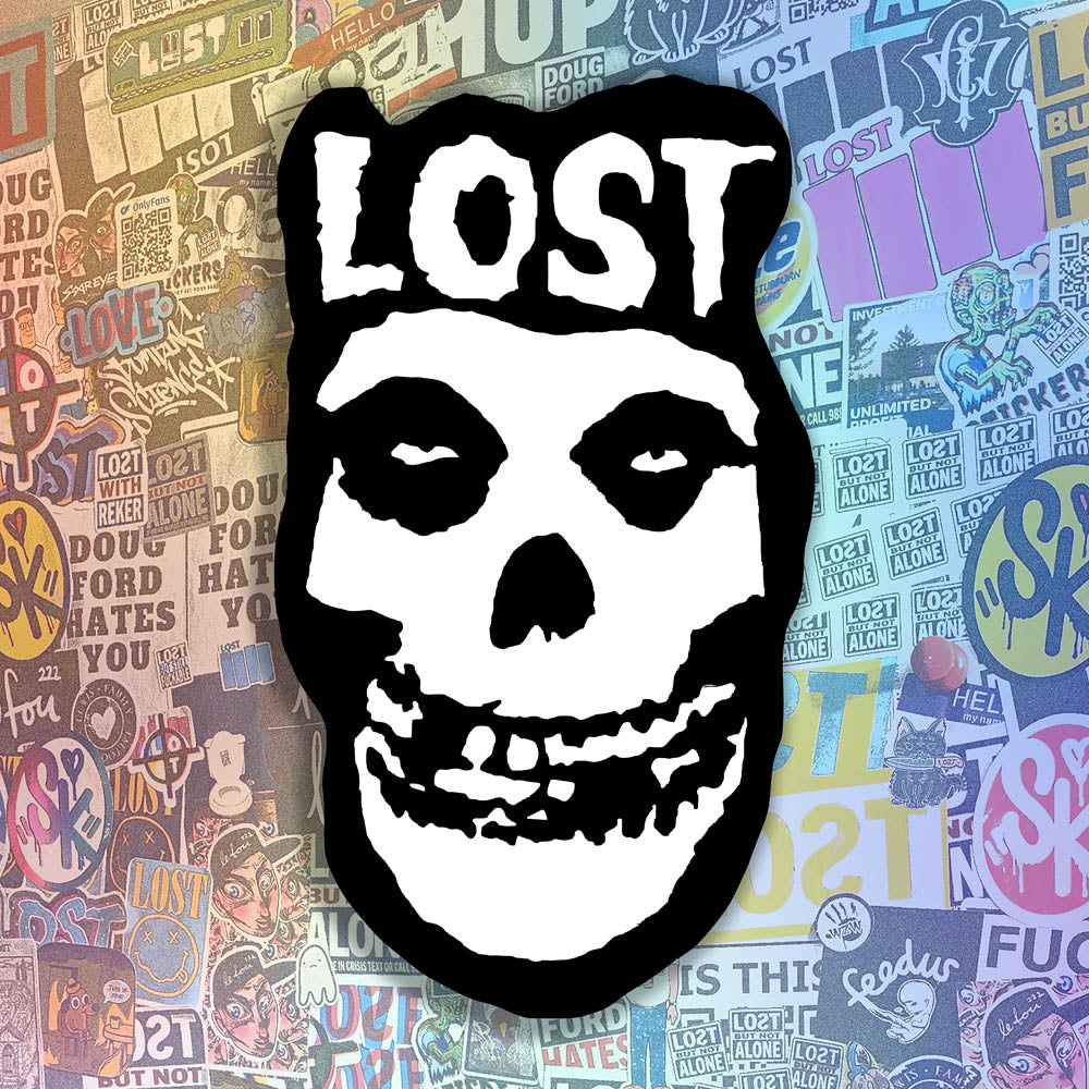 The Crimson Ghost Graffiti Sticker by LOST. A modern example of the classic black and white skull logo re-invented. The Word LOST is scrawled across the top in Bold white letters.