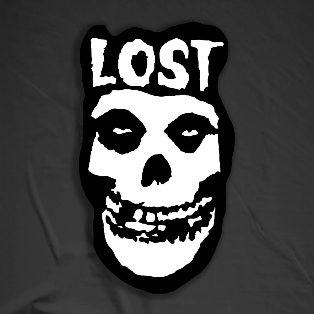 The Crimson Ghost Graffiti Sticker by LOST. A modern example of the classic black and white skull logo re-invented. The Word LOST is scrawled across the top in Bold white letters.