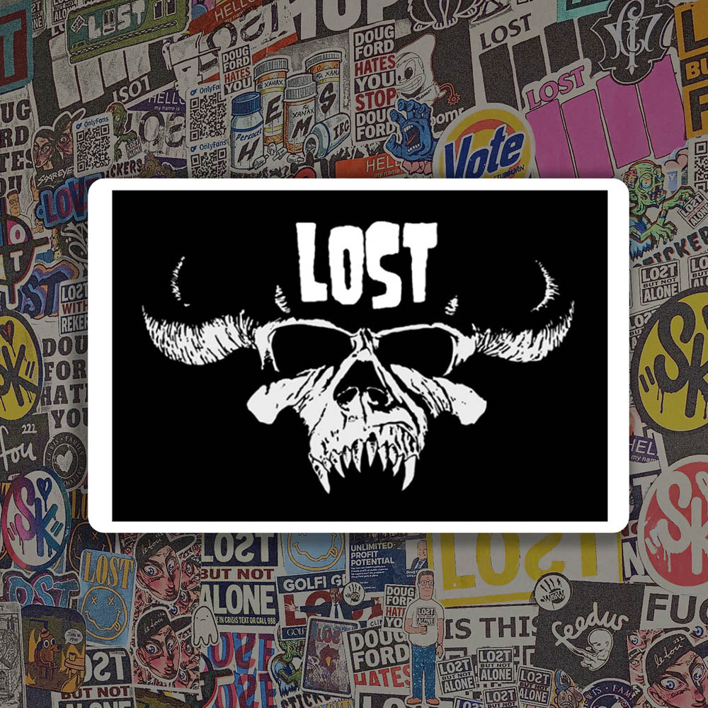 The Danzig thermal sticker by LOST. Black and white design featuring the Danzig skull with the text LOST. A wall of colorful graffiti stickers provides a unique background for the sticker.