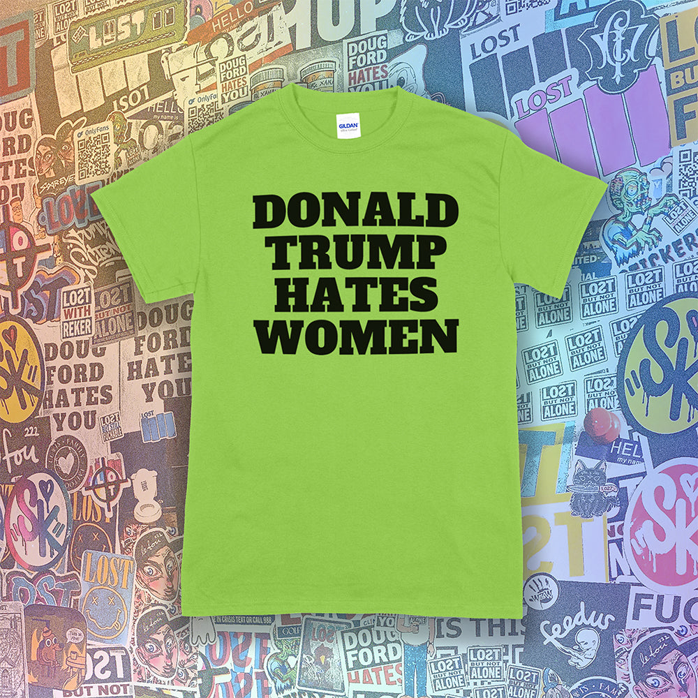 Donald Trump Hates Women t-shirt. Bold letters screen printed with black ink on a lime green shirt. A huge amount of graffiti stickers in the background.
