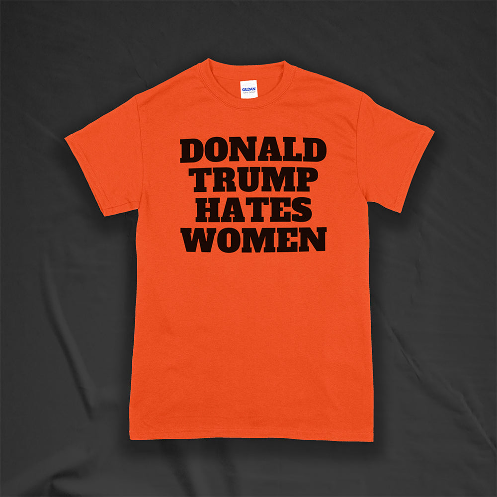 Donald Trump Hates Women t-shirt. Bold letters screen printed with black ink on an orange shirt.