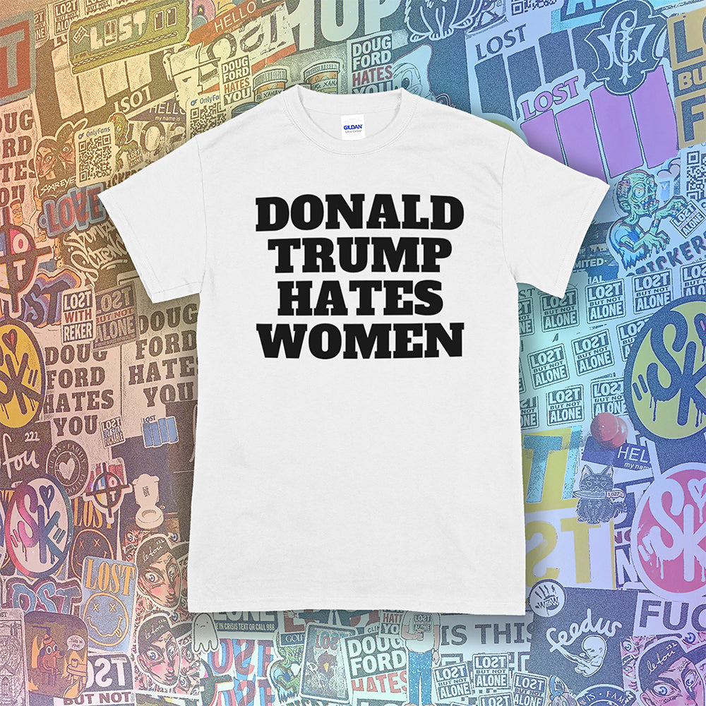 Donald Trump Hates Women t-shirt. Bold letters screen printed with black ink on a white shirt. A huge amount of graffiti stickers in the background.