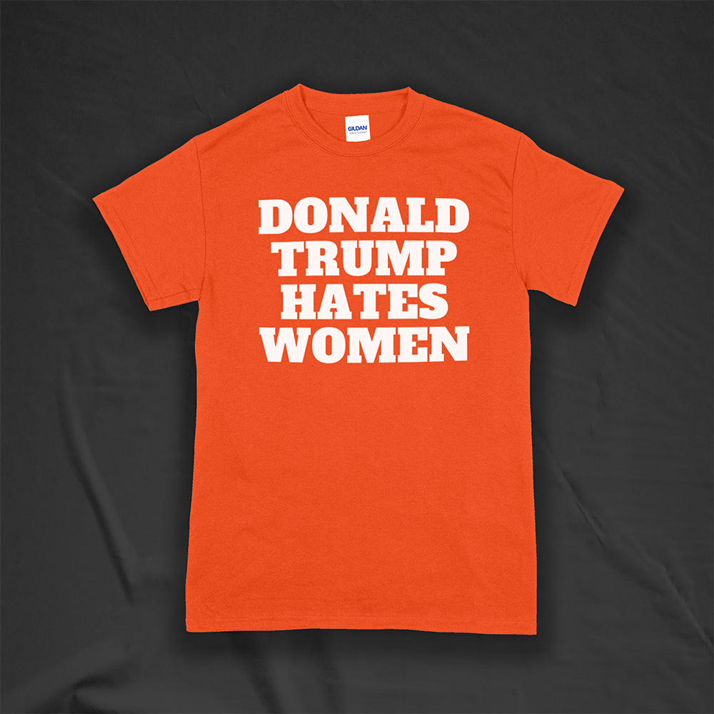 Donald Trump Hates Women t-shirt. Bold letters screen printed with white ink on an orange shirt.