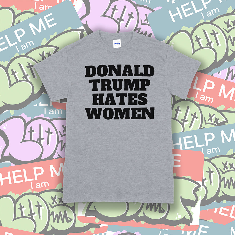 Donald Trump Hates Women t-shirt. Bold letters screen printed with black ink on a gray shirt. A huge amount of Lost graffiti stickers in the background.
