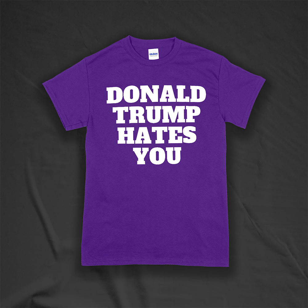 The Donald Trump Hates You t-shirt. Bold letters screen printed with white ink on a purple shirt.