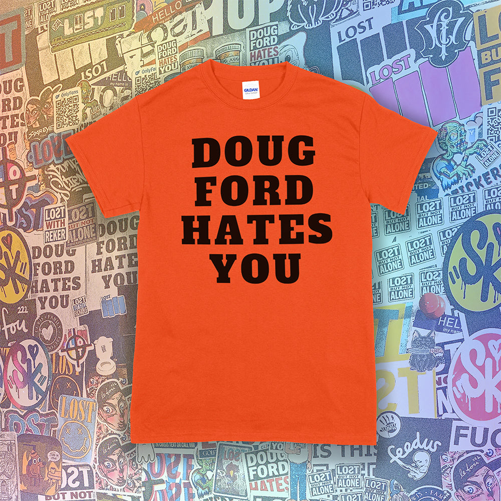 The original Doug Ford Hates You t-shirt. Bold black letters screen printed on an orange shirt. Assorted colorful graffiti stickers make up the background.