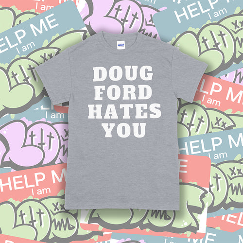 The original Doug Ford Hates You t-shirt. Bold white letters screen printed on a gray shirt. Colorful graffiti stickers make up the background.