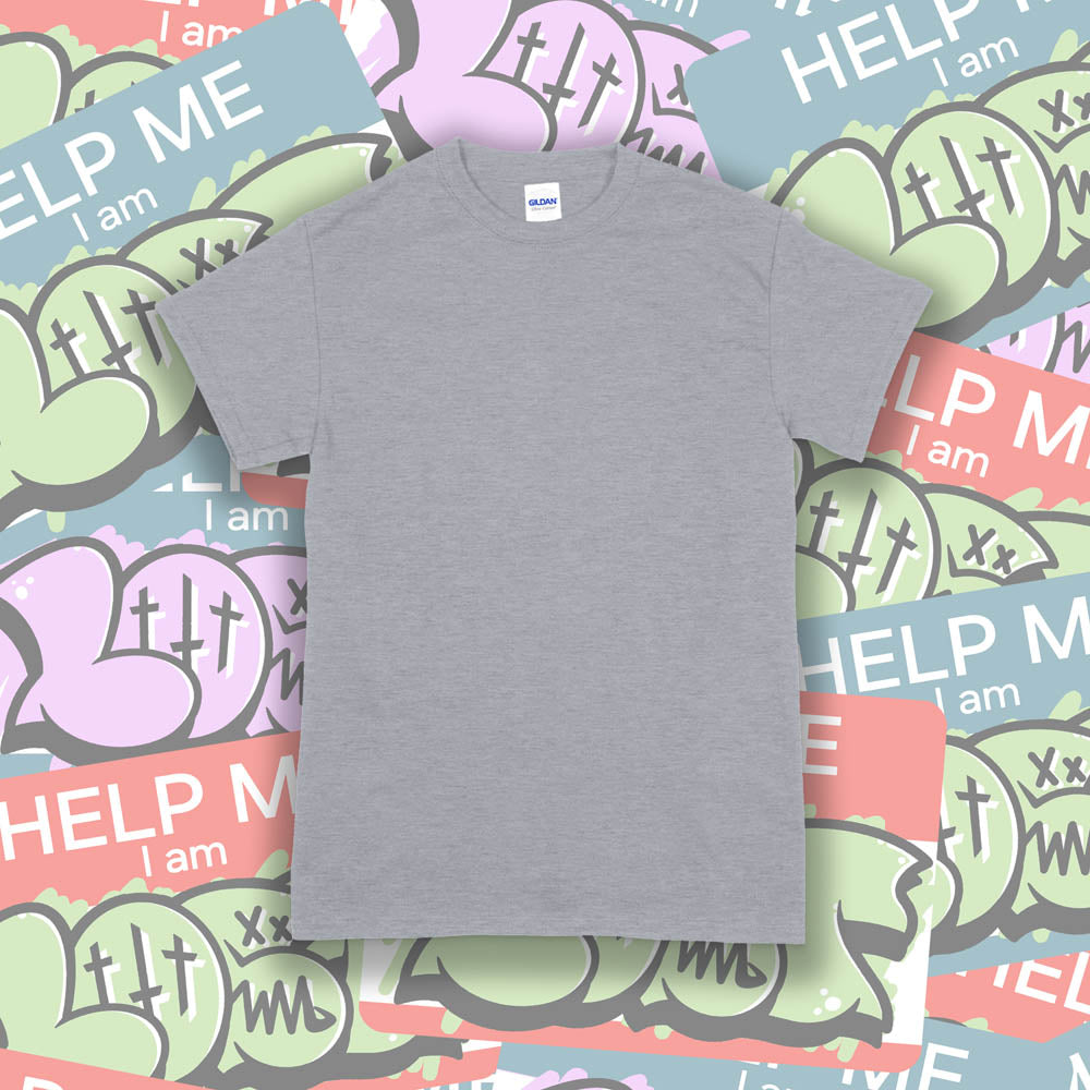 A blank Gildan shirt template. The plain gray Gildan t-shirt is displayed against a wall of colorful graffiti stickers.