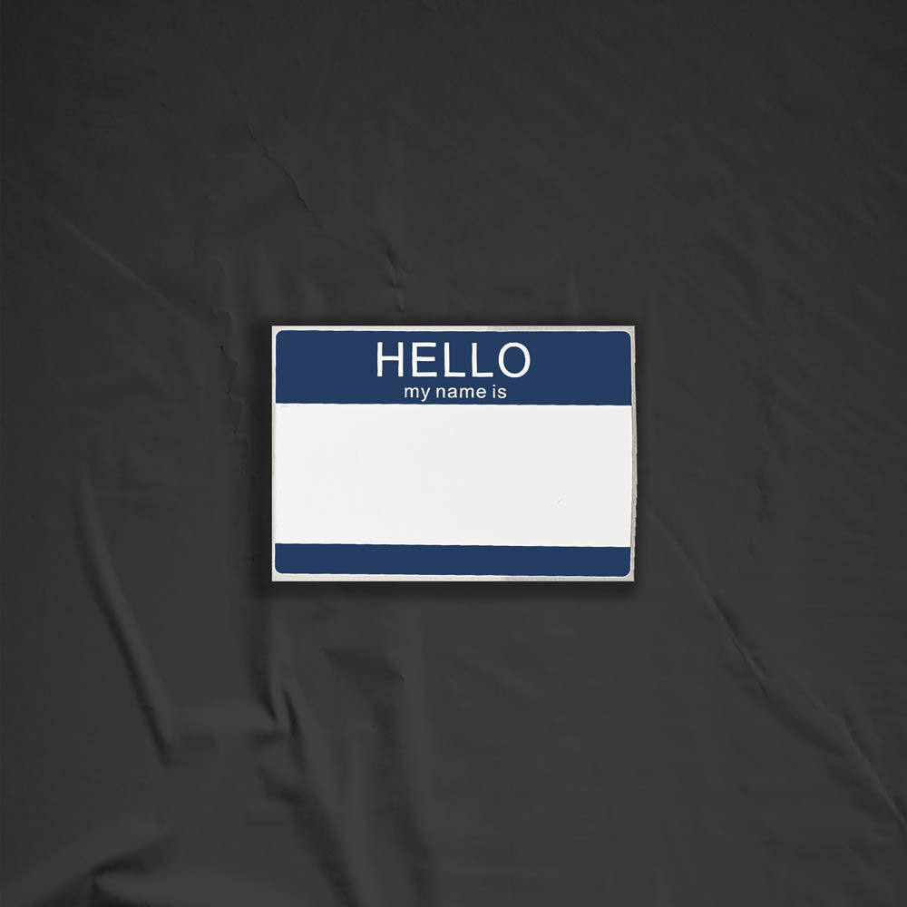 Hello my name is blank nametag sticker. A blue and white nametag sticker waiting to be tagged. The sticker is set against a black background.