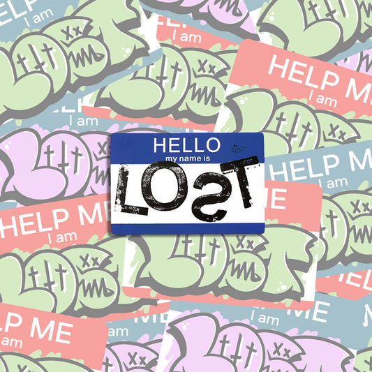 Hello my name is LOST sticker. A blue and white nametag sticker stamped with the name LOST with a backwards S. The sticker is set against a collection of colorful graffiti stickers.