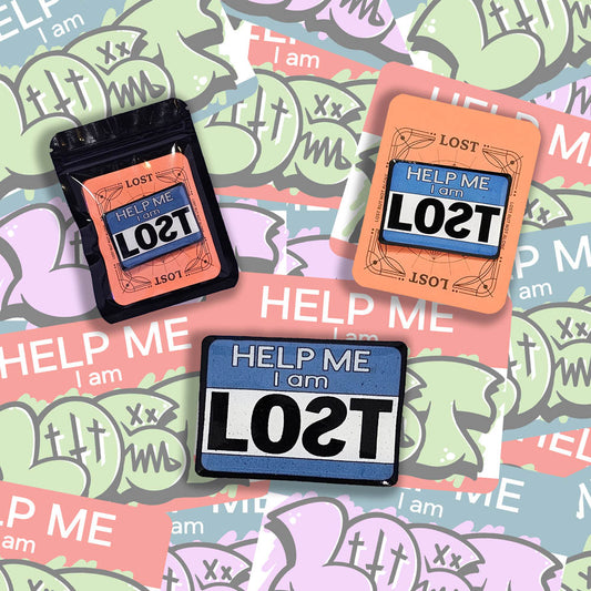 A display of three help me I am lost lapel pins. Blue pins set on a graffiti sticker background.