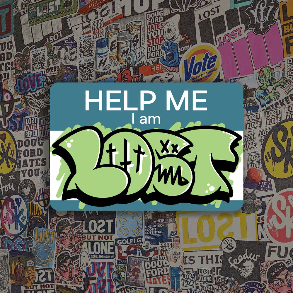 The Help Me I Am Lost graffiti nametag sticker. A blue hello my name is sticker edited to say Help Me I Am followed by a green and black LOST graffiti throwie.