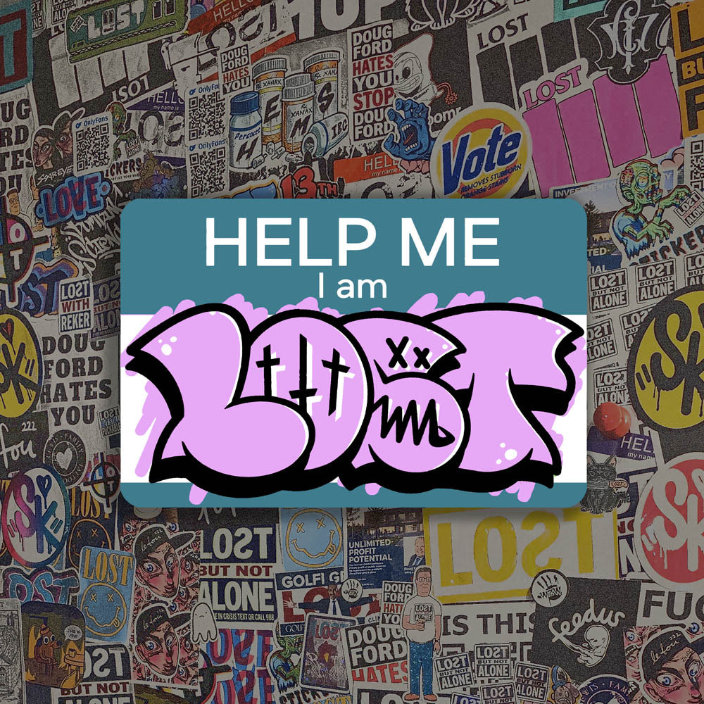 The Help Me I Am Lost graffiti nametag sticker. A blue hello my name is sticker edited to say Help Me I Am followed by a pink and black LOST graffiti throwie.