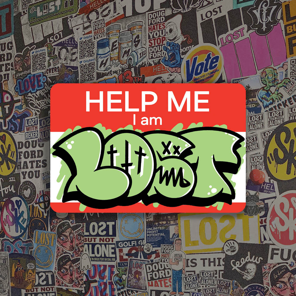 The Help Me I Am Lost graffiti nametag sticker. A red hello my name is sticker edited to say Help Me I Am followed by a green and black LOST graffiti throwie.