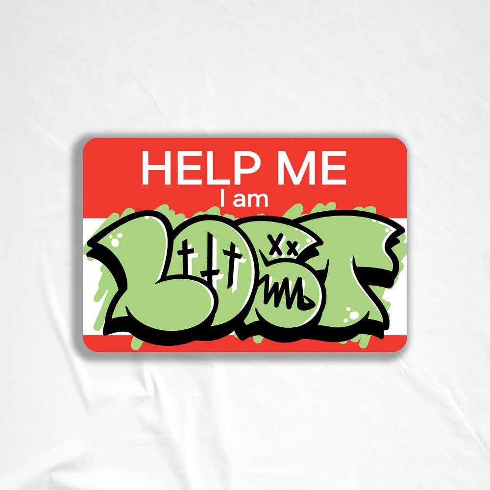 The Help Me I Am Lost graffiti nametag sticker. A red hello my name is sticker edited to say Help Me I Am followed by a green and black LOST graffiti throwie.