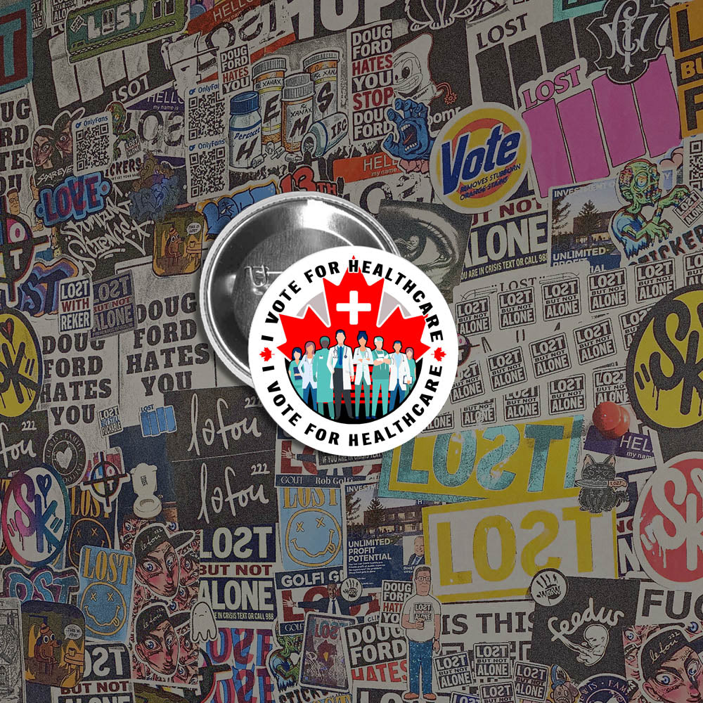 An I Vote For Healthcare pinback button  by Christopher Reilly on display against a colorful wall of graffiti stickers.