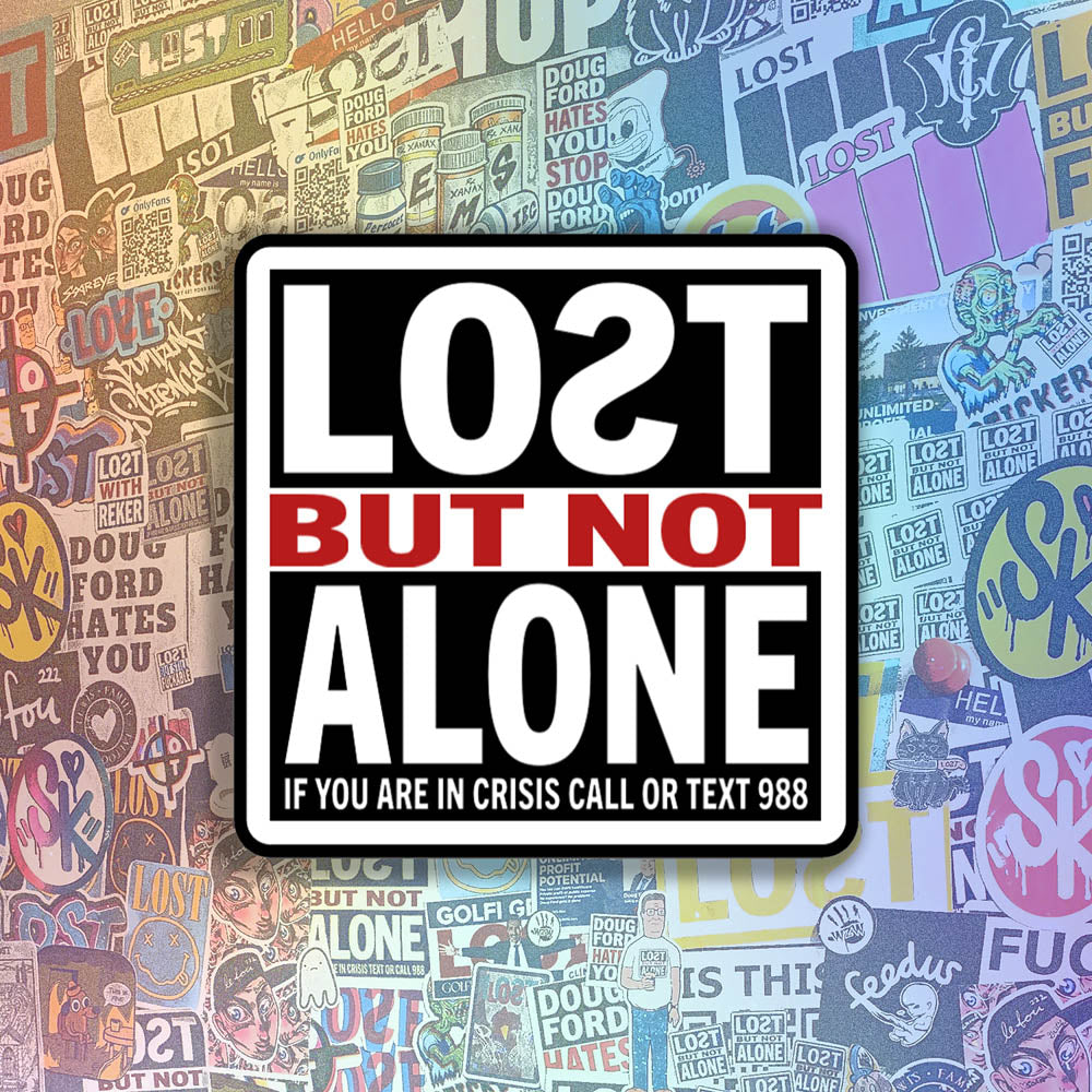 The Lost But Not Alone Sticker by artist and mental health advocate Christopher Reilly. This squared sticker features text stating Lost But Not Alone, if you are in crisis call or text 988. The black, white and red sticker design promotes mental health awareness and suicide prevention. A wall of colorful graffiti stickers by artists from around the world provides the backdrop for this sticker.