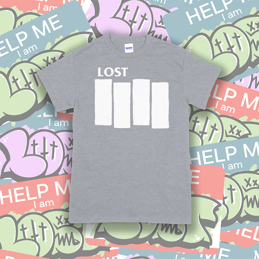 The Lost Flag t-shirt. The iconic bold logo is screen printed in white ink on a grey cotton shirt. A collection of colorful graffiti stickers make up the background. 