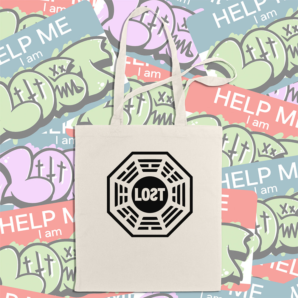 The bold and iconic octagon logo with the word LOST printed in bold black ink and displayed on a large natural canvas tote bag. An assortment of colorful graffiti stickers makes up the display background.  