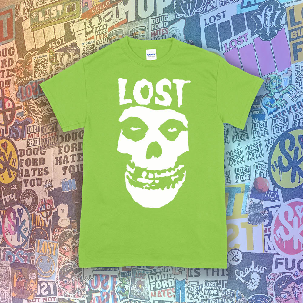 The Lost Crimson Ghost t-shirt. A Bold white skull screen printed and displayed on a bright green shirt. An assortment of graffiti stickers sets the background for this classic design upgraded by Lost Streetwear.