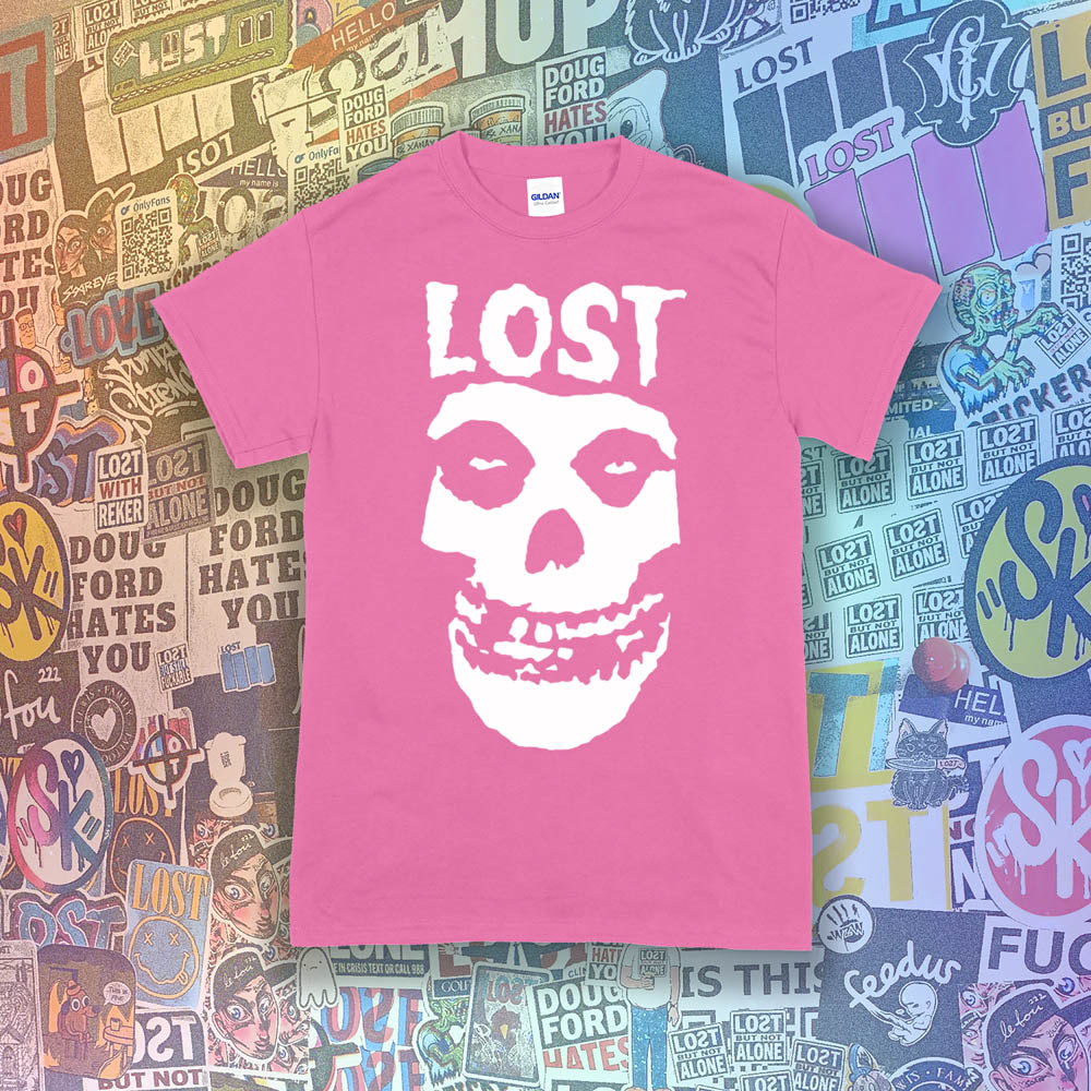 The Lost Crimson Ghost t-shirt. A Bold white skull screen printed and displayed on a bright pink shirt. An assortment of graffiti stickers sets the background for this classic design upgraded by Lost Streetwear.