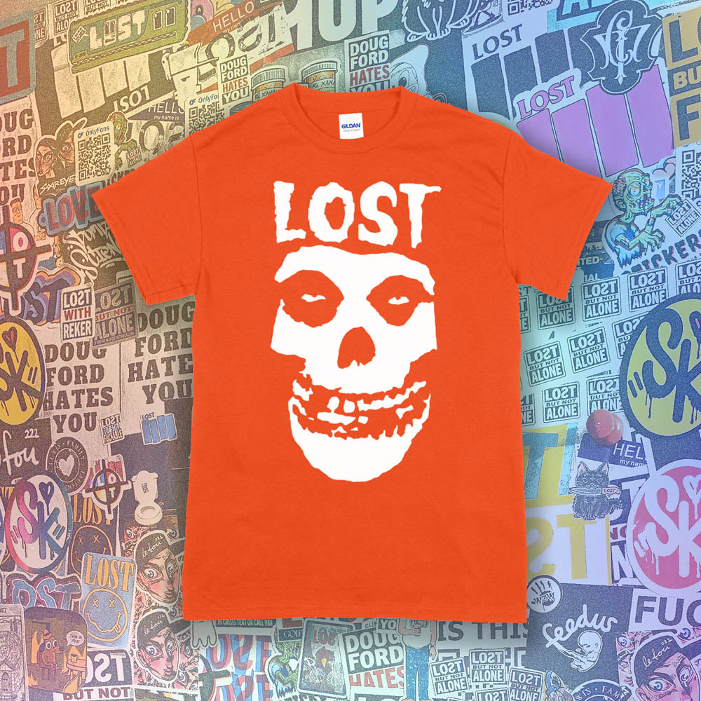 The Lost Crimson Ghost t-shirt. A Bold white skull screen printed and displayed on an orange shirt. An assortment of graffiti stickers sets the background for this classic design upgraded by Lost Streetwear.