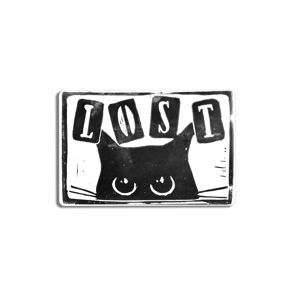 Peekers the cat graffiti sticker by LOST. A black and white image of a black cat peeking out at you with LOST written in above it. The sticker is set against a white background.