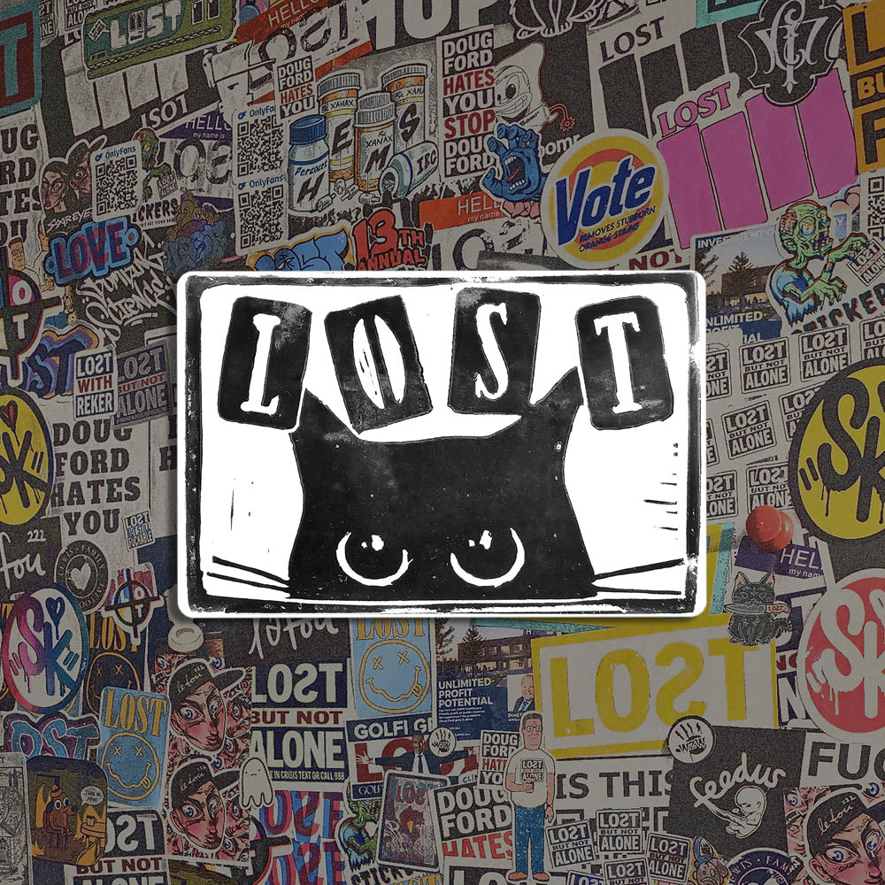 Peekers the cat graffiti sticker by LOST. A black and white image of a black cat peeking out at you with LOST written in above it. The sticker is set against a collection of colorful graffiti stickers.