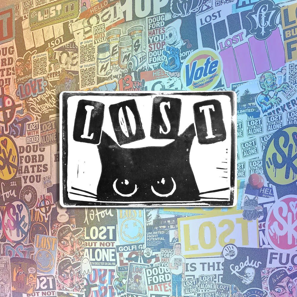 Peekers the cat graffiti sticker by LOST. A black and white image of a black cat peeking out at you with LOST written in above it. The sticker is set against a collection of colorful graffiti stickers.