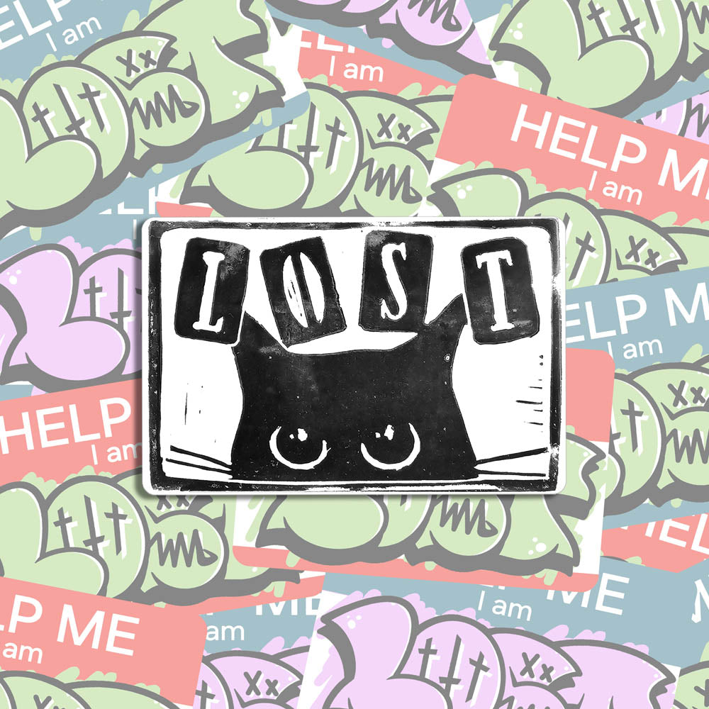 A hand stamped graffiti sticker by LOST. Black print of a cat on a white rectangular sticker with rounded corners. The sticker is shown against a wall of colorful graffiti stickers.