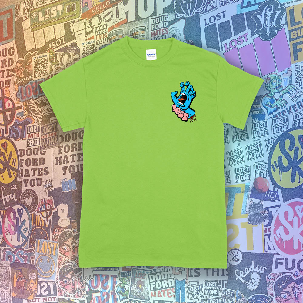The screaming hand t-shirt re-design by Lost Streetwear. Full color severed hand graphic printed and displayed on a lime green t-shirt. A wall of graffiti stickers by artists from around the world provides a colorful background for this re-imagined classic design.