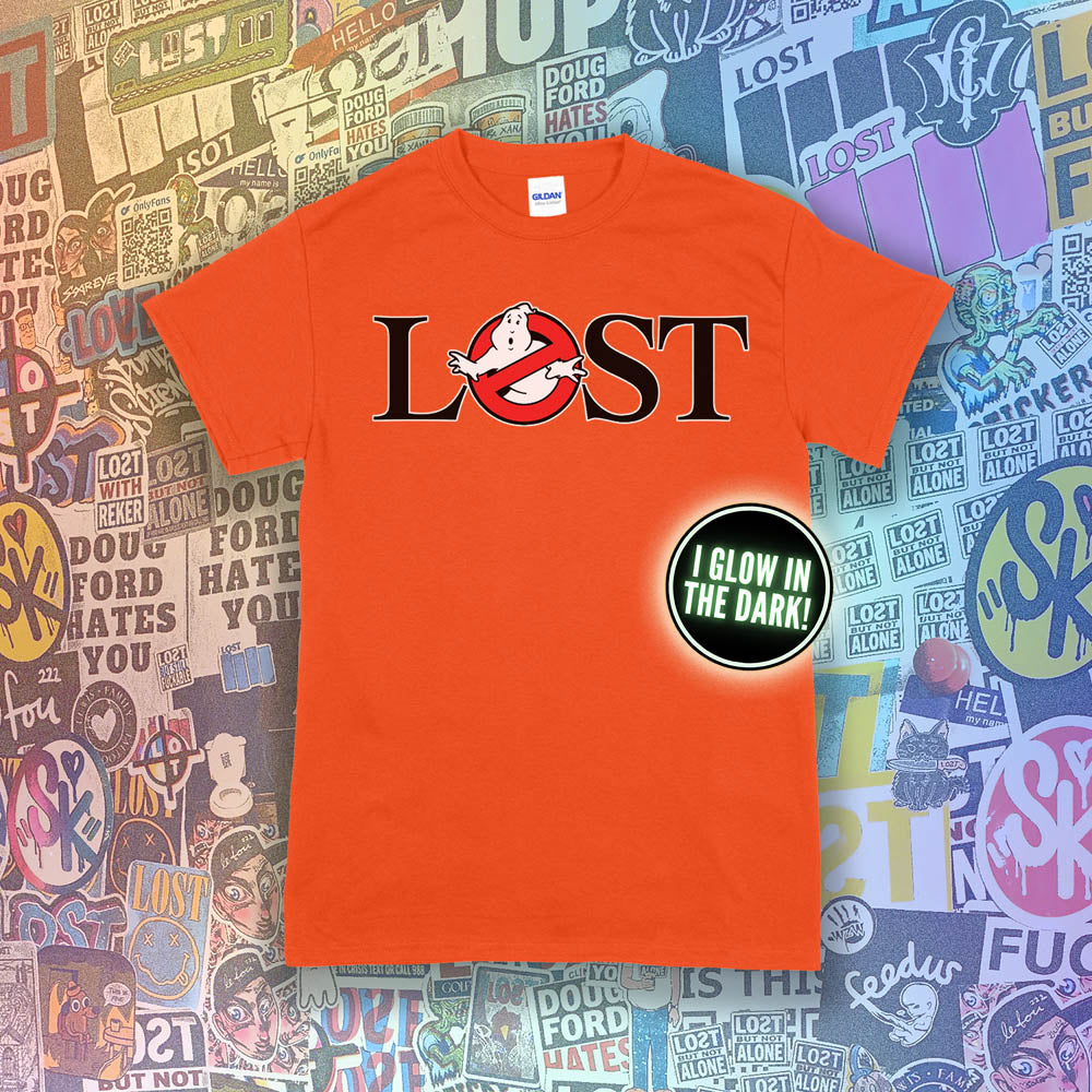 Who ya gonna call? Lostbusters! Screen printed logo with a glow in the dark ghost. Printed and displayed on a bright orange t-shirt with a collection of graffiti stickers providing the background.