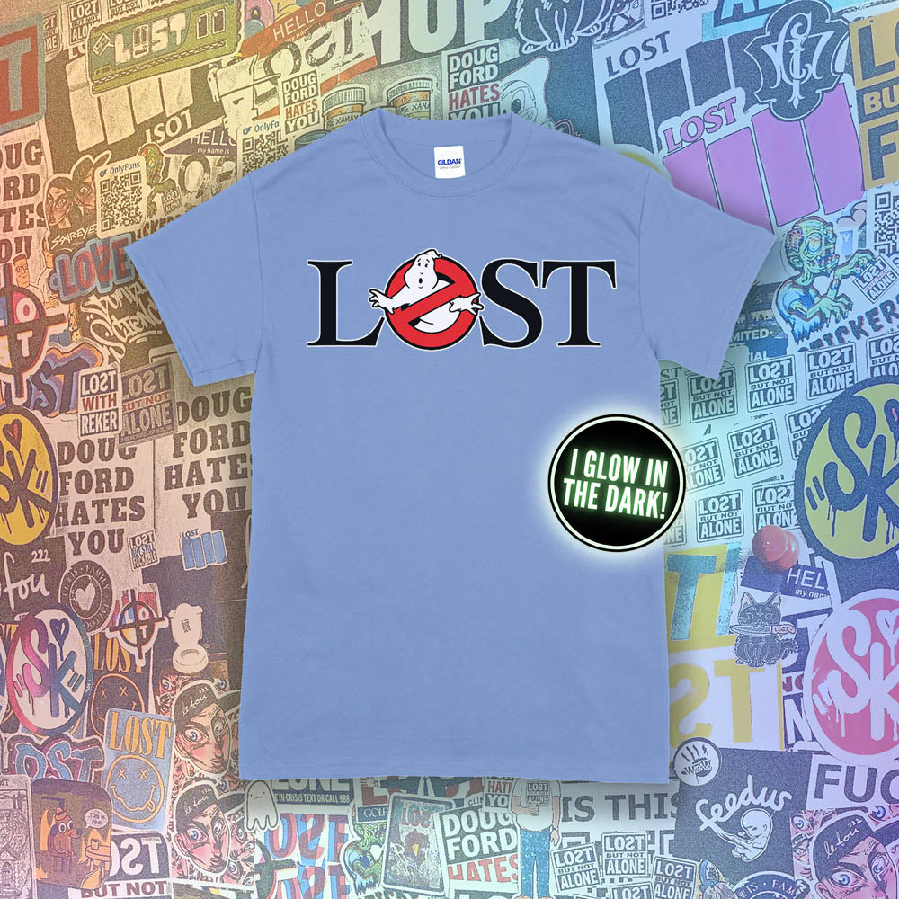 Who ya gonna call? Lostbusters! Screen printed logo with a glow in the dark ghost. Printed and displayed on a Carolina blue t-shirt with a collection of graffiti stickers providing the background.