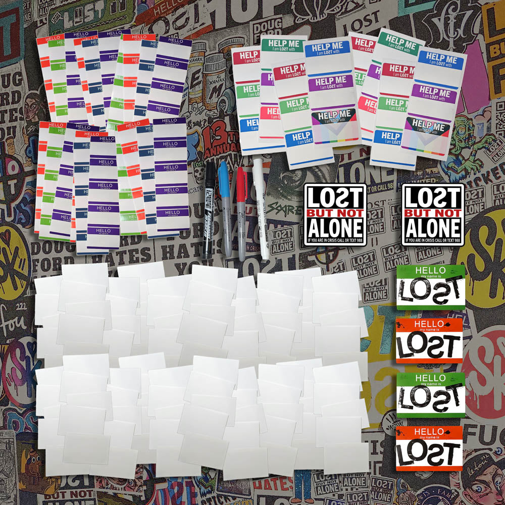 A selection of blank graffiti stickers and markers laid of for display.