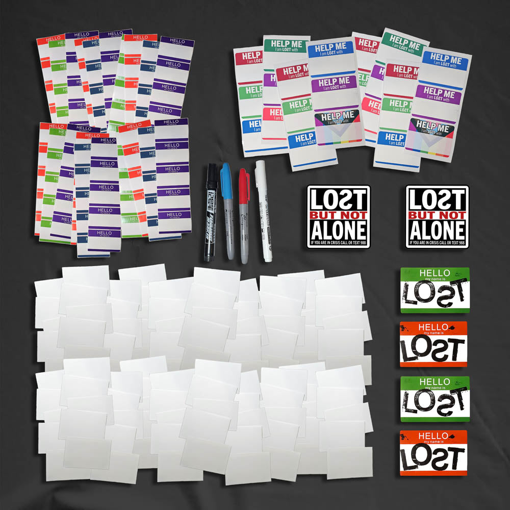 A selection of blank graffiti stickers and markers laid of for display.