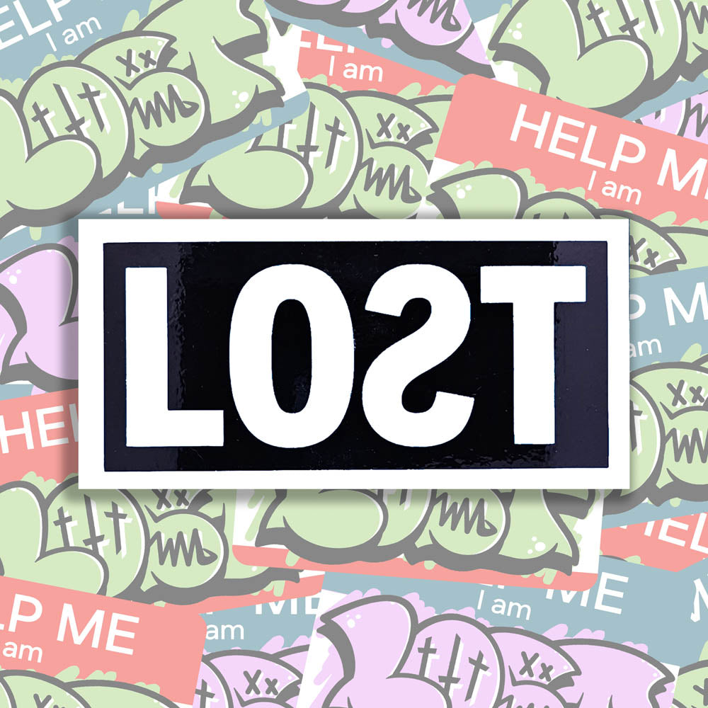 The original graffiti sticker by LOST. A simple two color cut design featuring the word LOST written with a backwards S in white and contained within a glossy black rectangle. The sticker is set against a collection of colorful graffiti stickers.