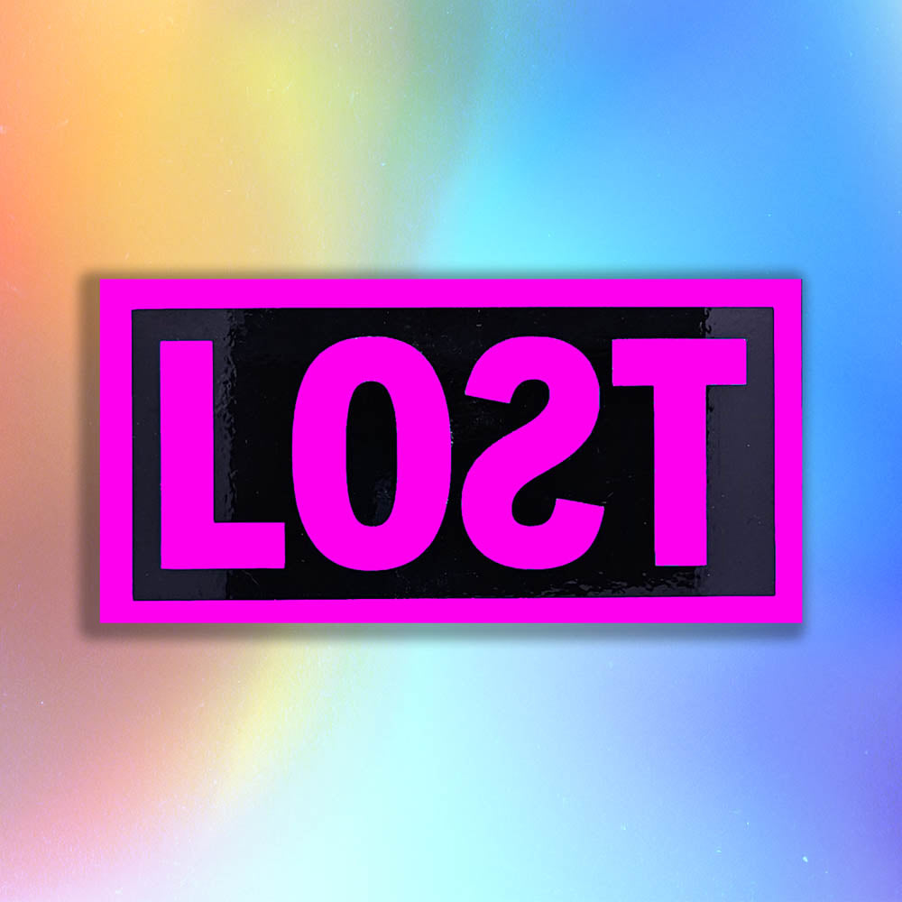 The original graffiti sticker by LOST. A simple two color cut design featuring the word LOST written with a backwards S  in hot pink and contained within a glossy black rectangle. The sticker is set against a rainbow holographic background.