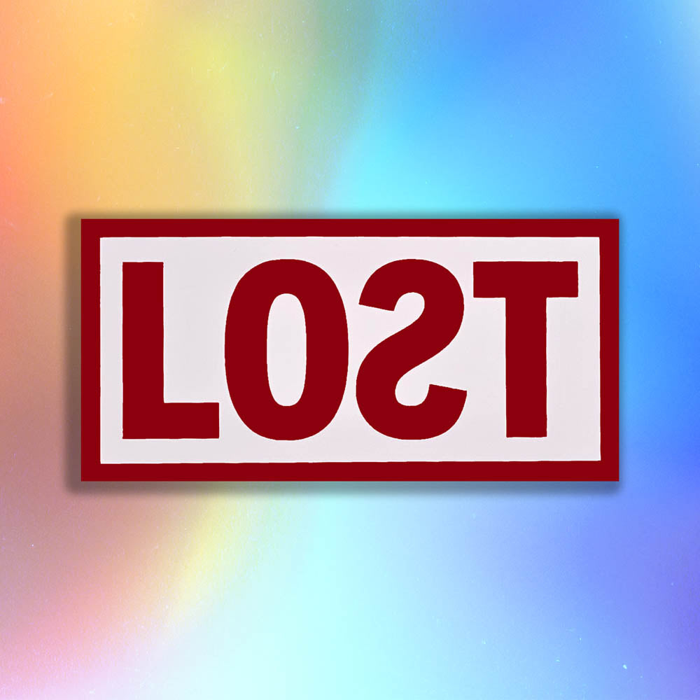 The original graffiti sticker by LOST. A simple two color cut design featuring the word LOST written with a backwards S in deep red and contained within a matte white rectangle. The sticker is set against a rainbow holographic background.