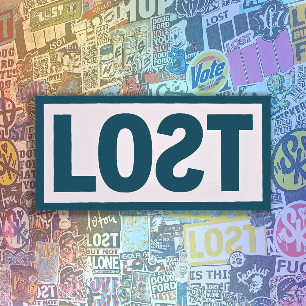 The original graffiti sticker by LOST. A simple two color cut design featuring the word LOST written with a backwards S in a greyish blue and contained within a matte white rectangle. The sticker is set against a wall of colorful graffiti stickers by artists from around the world.