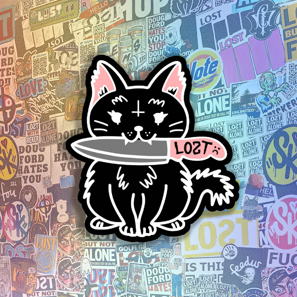 Pancake graffiti sticker. This die-cut sticker features the black cat Pancake holding a knife in her mouth. A wall of colorful graffiti stickers provides the background for this display.