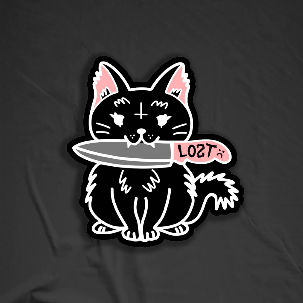 Pancake graffiti sticker. This die-cut sticker features the black cat Pancake holding a knife in her mouth. The cat shaped sticker is displayed against a black background.