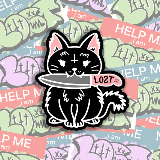 Pancake graffiti sticker. This die-cut sticker features the black cat Pancake holding a knife in her mouth. A wall of colorful graffiti stickers provides the background for this display.