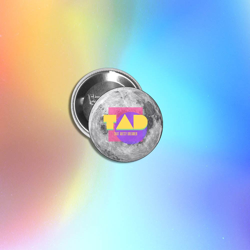 A custom pinback button made by reilly9578. The colorful button is set against a holographic rainbow background.