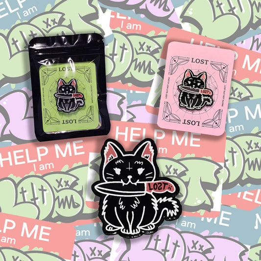 A display of three Peekers Peeking lapel pins by Lost. The pins feature a black cat holding a knife set against a graffiti sticker background.