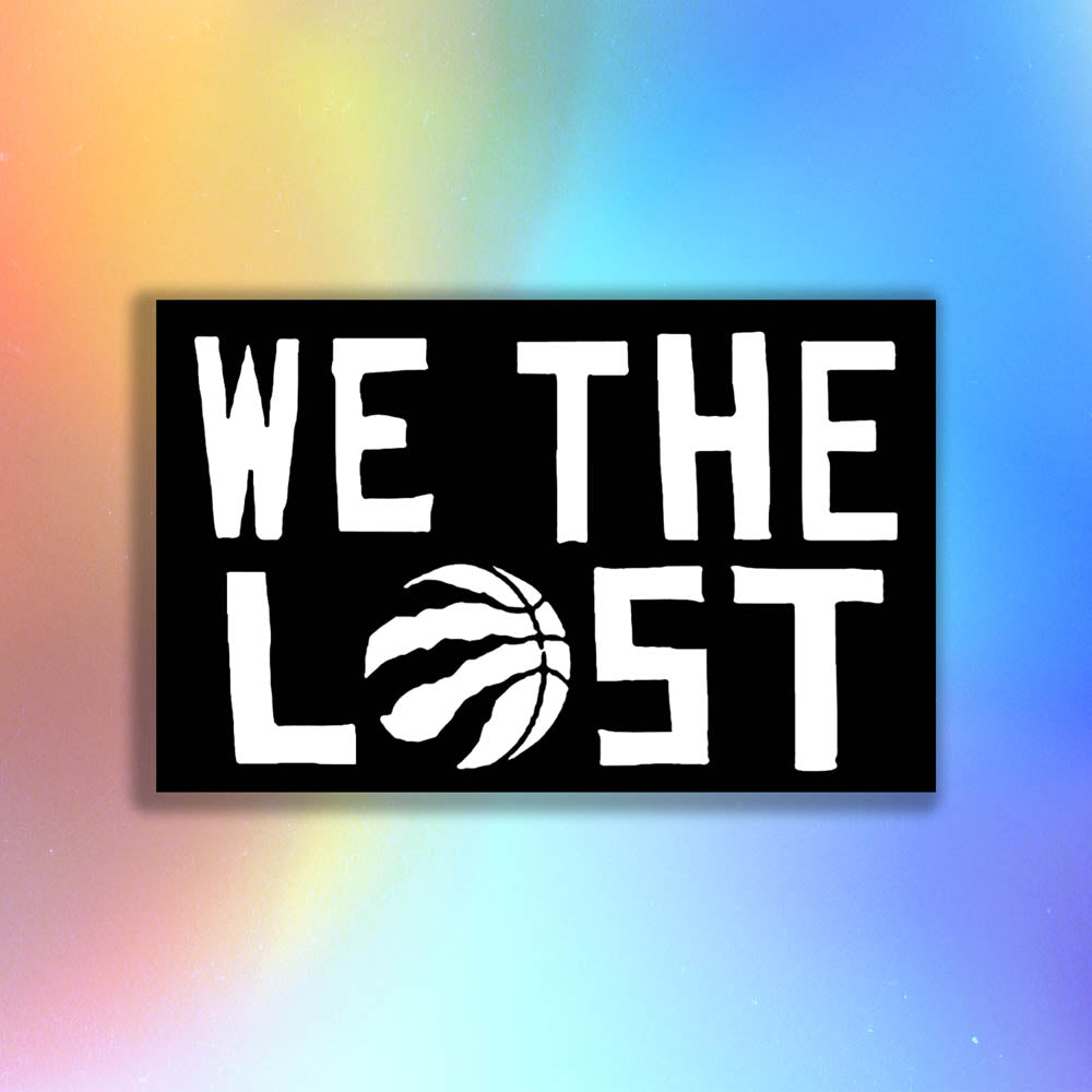 The We The Lost graffiti sticker. Bold white lettering and raptor claw design on a black sticker. The O in the word LOST is a basketball with claws. The sticker is set against a holographic background.