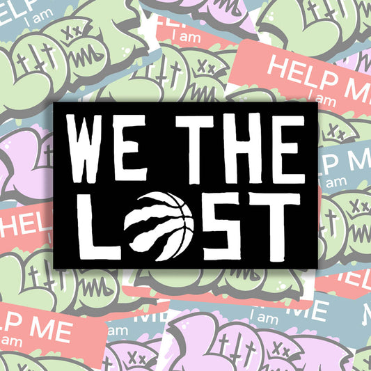 The We The Lost graffiti sticker. Bold white lettering and raptor claw design on a black sticker. The O in the word LOST is a basketball with claws. The sticker is set against a background of colorful graffiti stickers