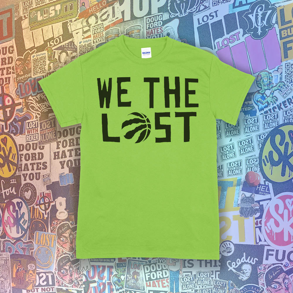 We The Lost t-shirt. Bold black lettering and raptor claw design screen printed on a lime green shirt. A wall of colorful graffiti stickers make up the background.